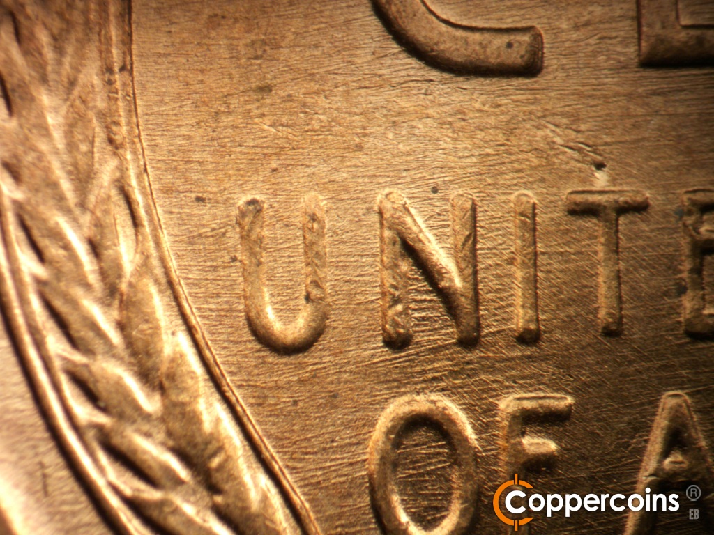 Die-stage B marker on 1957D•1MM•109 showing Die scratches through UNITED and OF.