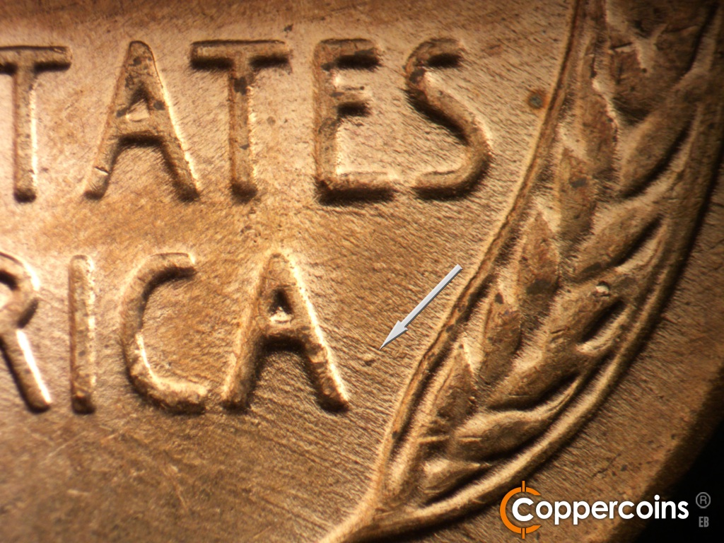 Die-stage C marker on 1957D•1MM•110 showing Die dot eat of last A in AMERICA. SE die scratches cover lower right of reverse.