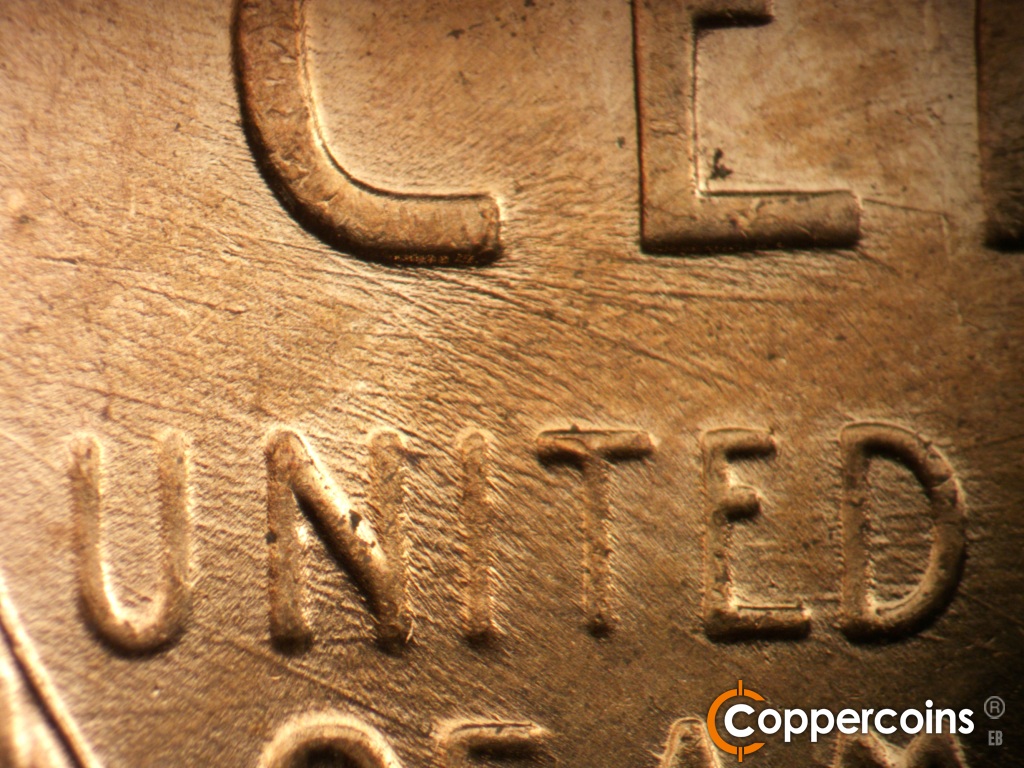 Die-stage C marker on 1957D•1MM•110 showing Die scratches through UNITED.