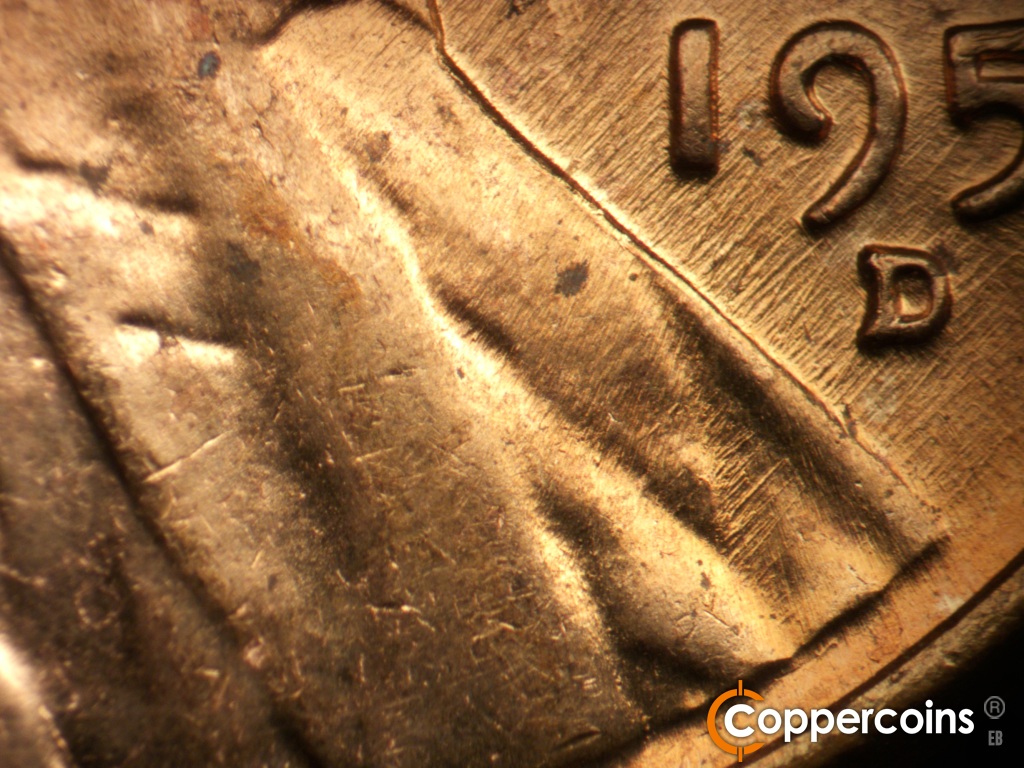 Die-stage B marker on 1957D•1MM•111 showing NE die scratches on bottom of lapel.