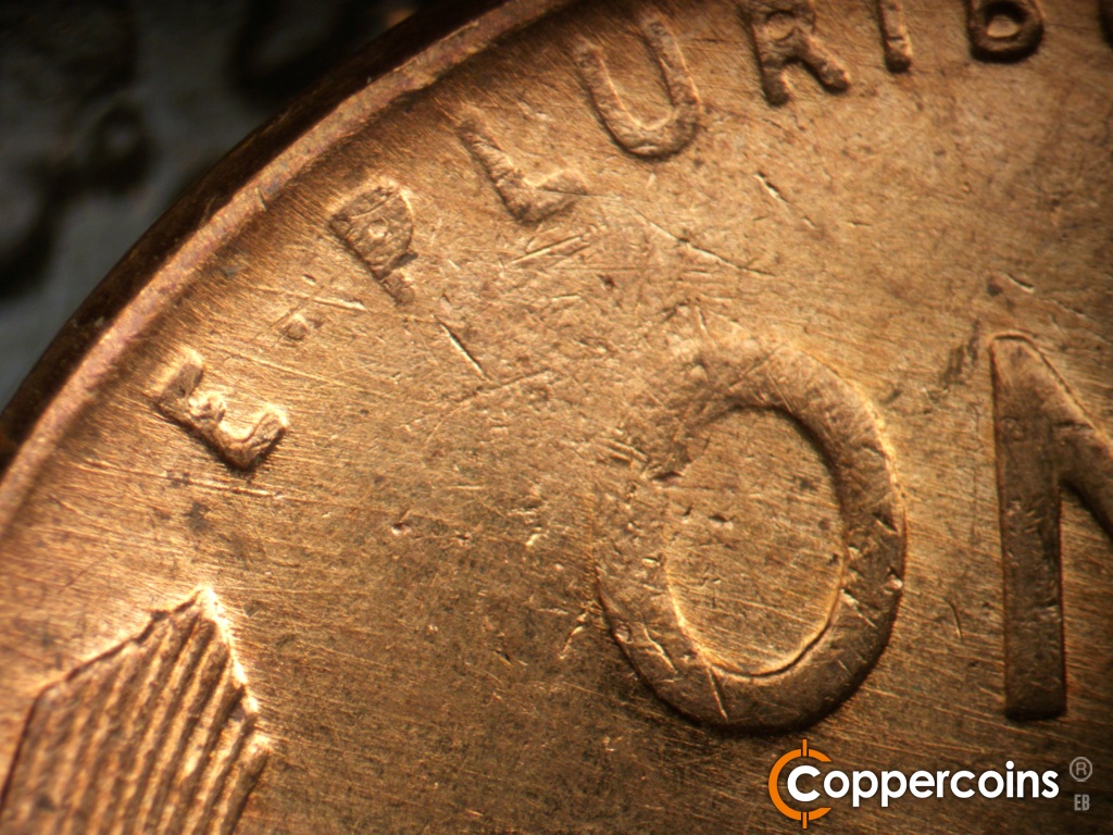 Die-stage B marker on 1957D•1MM•111 showing ESE die scratches cover upper left of reverse.