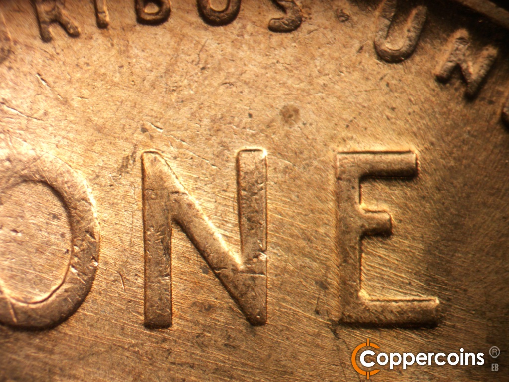 Die-stage B marker on 1957D•1MM•111 showing ESE die scratches through ONE.