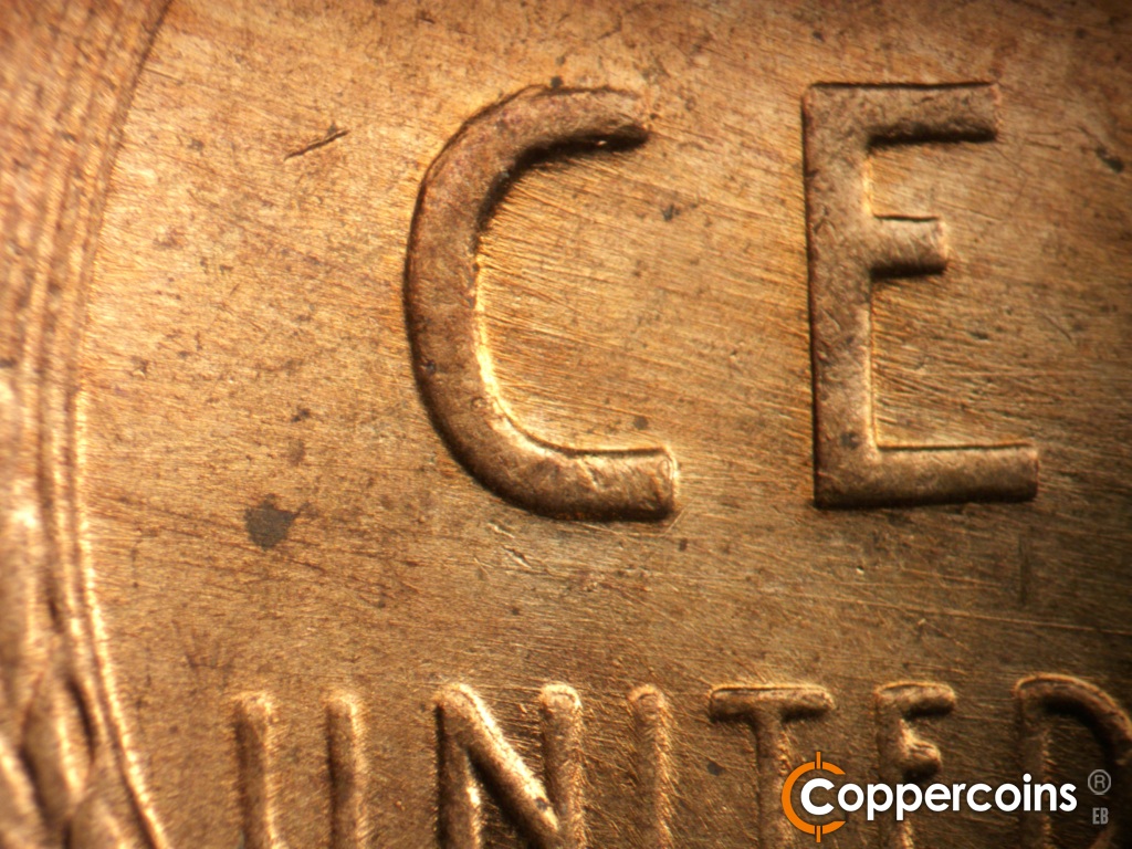 Die-stage B marker on 1957D•1MM•111 showing ESE die scratches through CE in CENT.