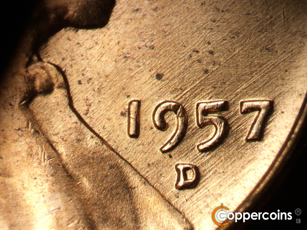 Die-stage B marker on 1957D•1MM•112 showing NE die scratches through date.