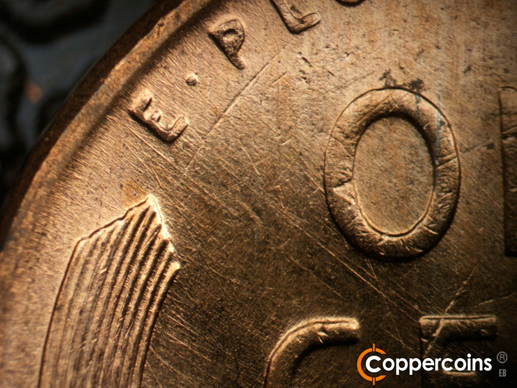 Die-stage B marker on 1957D•1MM•112 showing SE die scratches from E in E PLURIBUS.