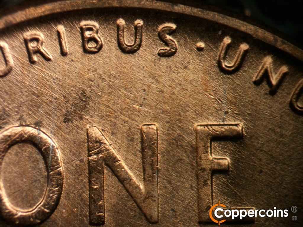 Die-stage B marker on 1957D•1MM•112 showing Die scratches cover top of reverse.