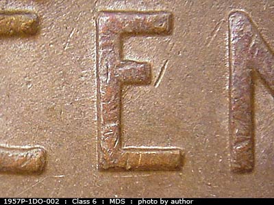 Die-stage B marker on 1957P•1DO•002 (1957 Doubled Die Obverse).