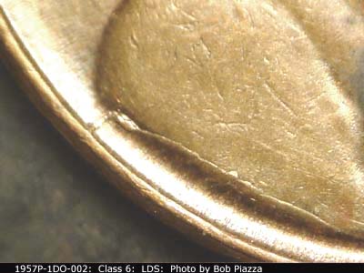 Die-stage C marker on 1957P•1DO•002 (1957 Doubled Die Obverse).