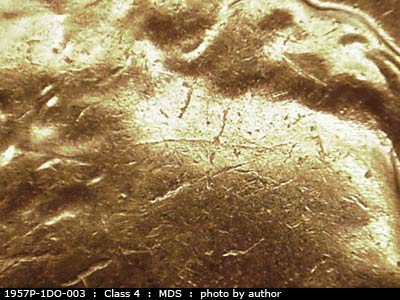 Die-stage B marker on 1957P•1DO•003 (1957 Doubled Die Obverse).