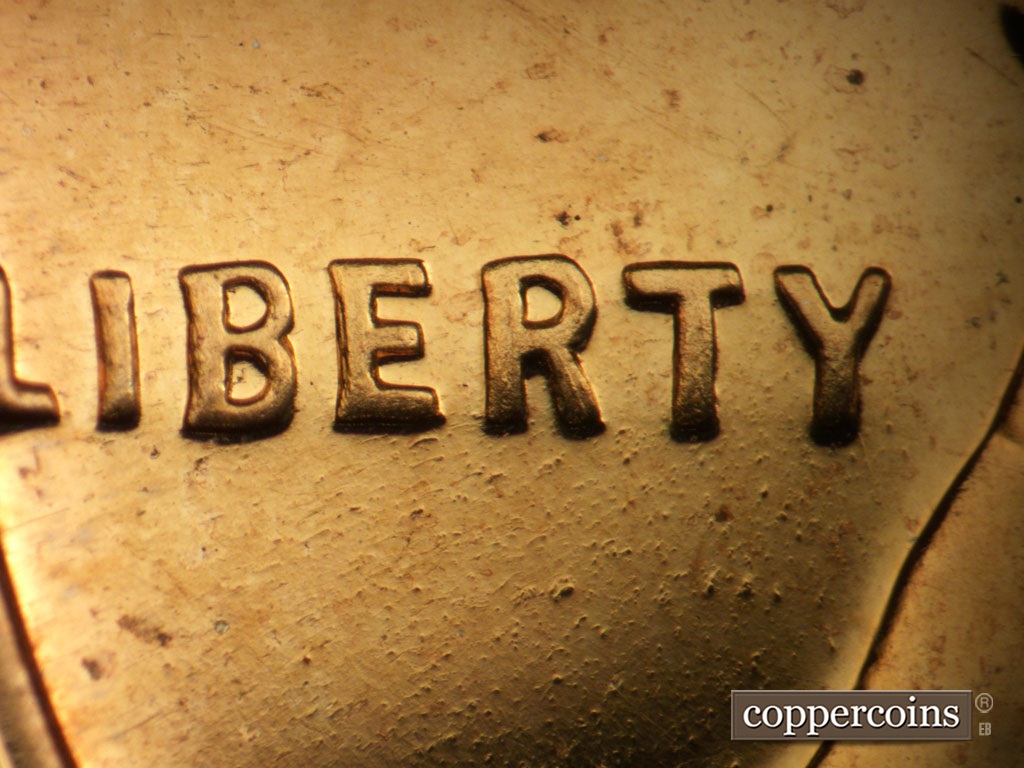 Die-stage B marker on 1957P•1DO•005P showing Extra thickness on LIBERTY.