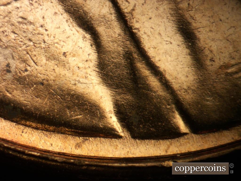 Die-stage B marker on 1957P•1DO•007 showing Concentric die scratches on jacket.