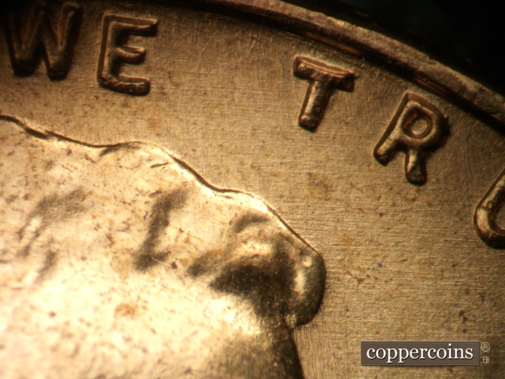 Die-stage B marker on 1957P•1DO•007 showing E/W die scratches in field under TRUST.