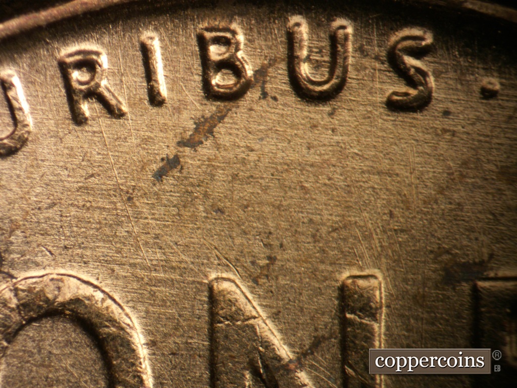 Die-stage B marker on 1957P•1DO•007 showing Generally E/W die scratches cover top of reverse.