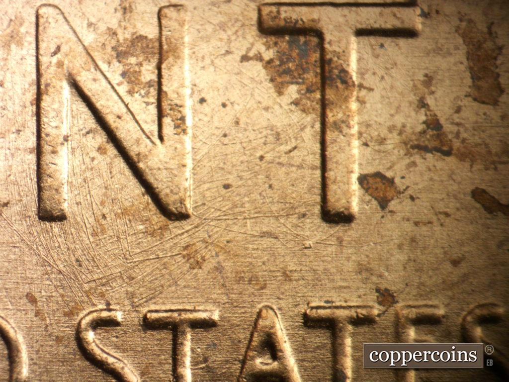 Die-stage B marker on 1957P•1DO•007 showing Die scrathces between NT in CENT and STATES.