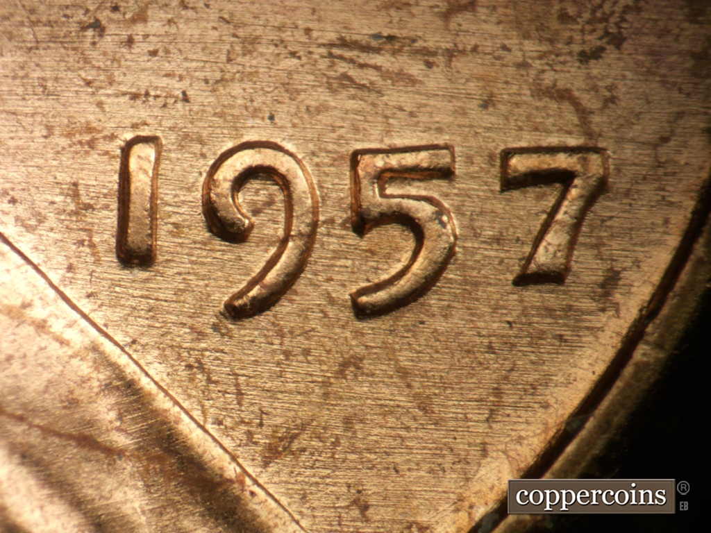 Die-stage A marker on 1957P•1DO•007 showing E/W die scratches through date.