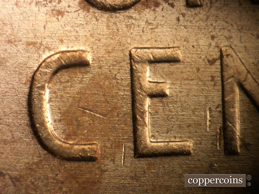 Die-stage A marker on 1957P•1DO•007 showing E/W die scratches through CE in CENT.