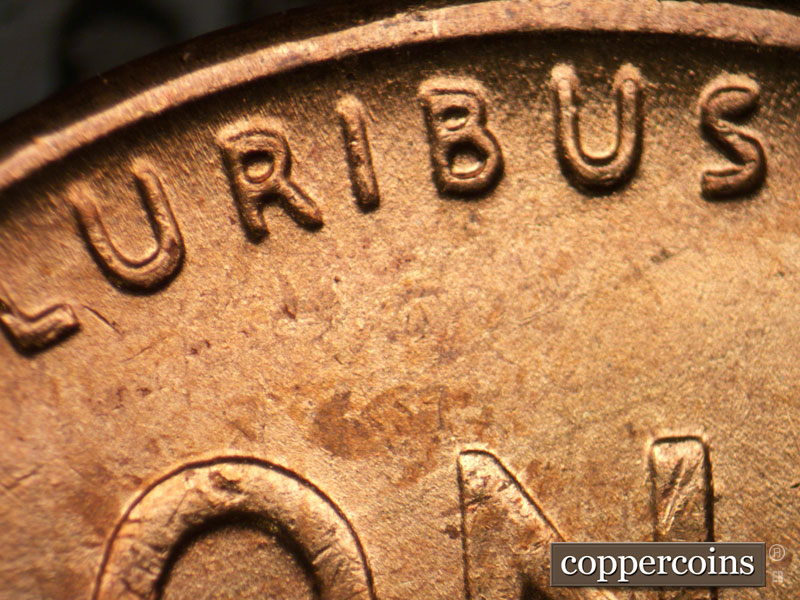 Die-stage B marker on 1957P•1DR•002 (1957 Doubled Die Reverse).