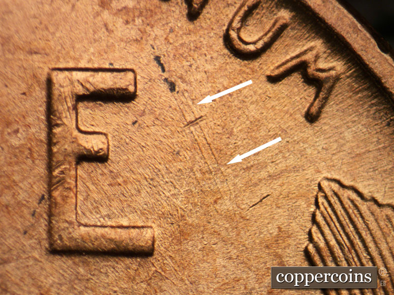 Die-stage B marker on 1957P•1DR•002 (1957 Doubled Die Reverse).