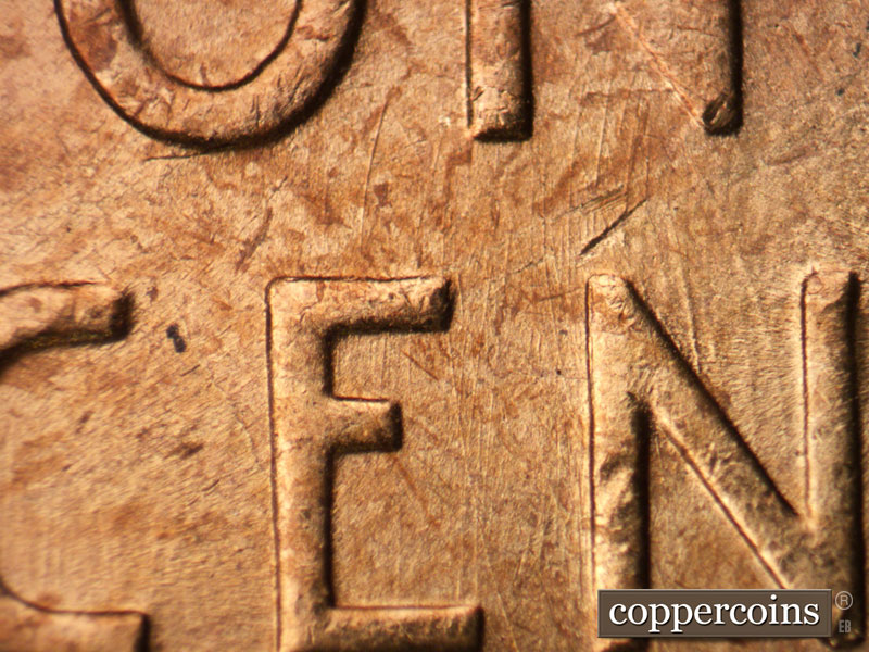 Die-stage B marker on 1957P•1DR•002 (1957 Doubled Die Reverse).
