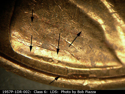 Die-stage C marker on 1957P•1DR•002 (1957 Doubled Die Reverse).