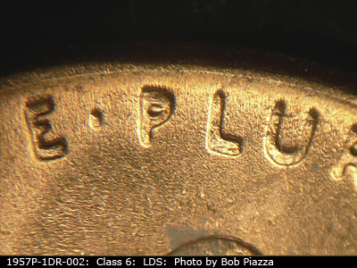 Die-stage C marker on 1957P•1DR•002 (1957 Doubled Die Reverse).