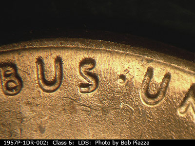 Die-stage C marker on 1957P•1DR•002 (1957 Doubled Die Reverse).