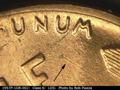 Die-stage C marker on 1957P•1DR•002 (1957 Doubled Die Reverse).