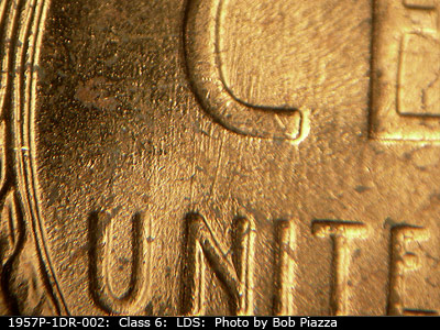 Die-stage C marker on 1957P•1DR•002 (1957 Doubled Die Reverse).