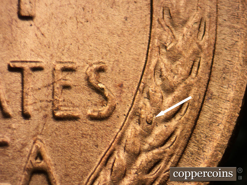 Die-stage B marker on 1957P•1DR•003 (1957 Doubled Die Reverse).