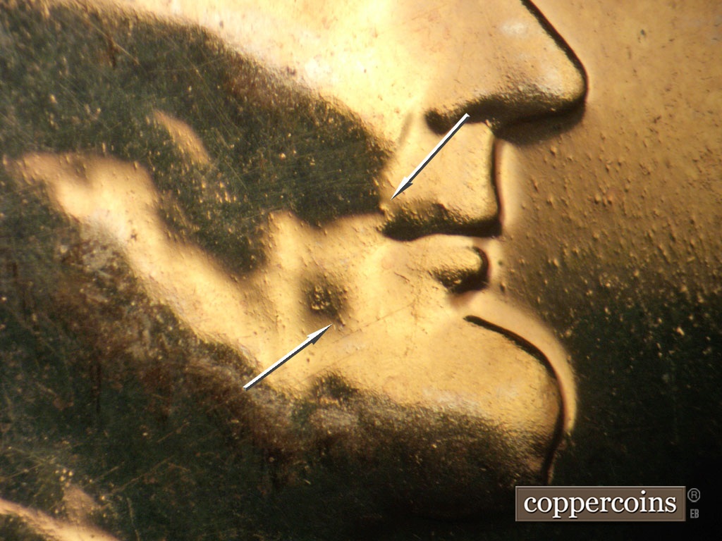 Die-stage A marker on 1957P•1DR•004P showing Die dots on lip and jaw.