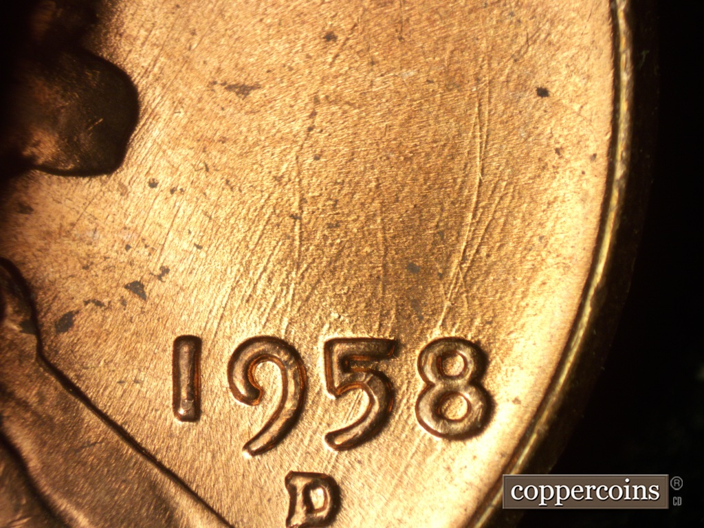 Die-stage B marker on 1958D•1MM•049 showing A heave die gouge runs on a leftward curve to the north from the 8 of the date.