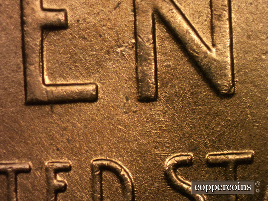 Die-stage B marker on 1958D•1MM•049 showing A patch of die gouges from die damage show to the left of the N of CENT.