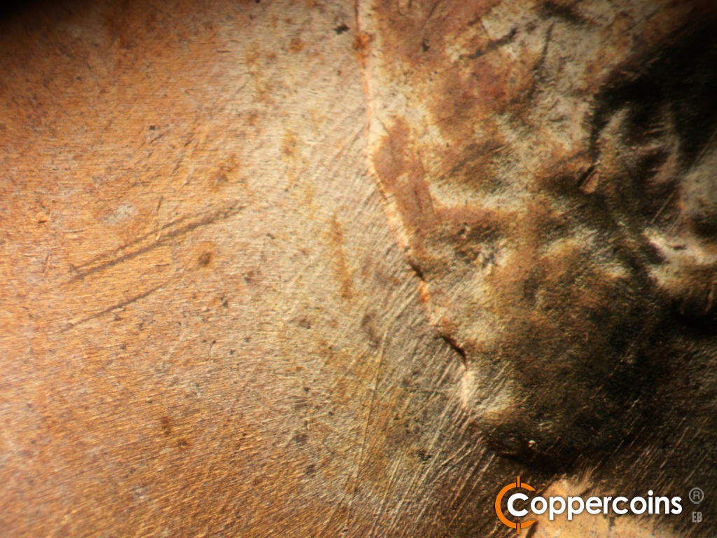 Die-stage B marker on 1958D•1MM•112 showing Die scratches in field behind hair.