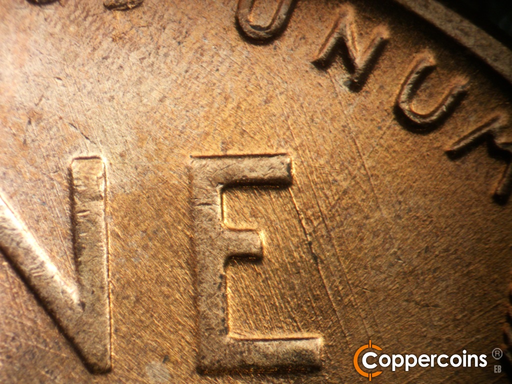 Die-stage B marker on 1958D•1MM•112 showing SE die scratches through E in ONE.