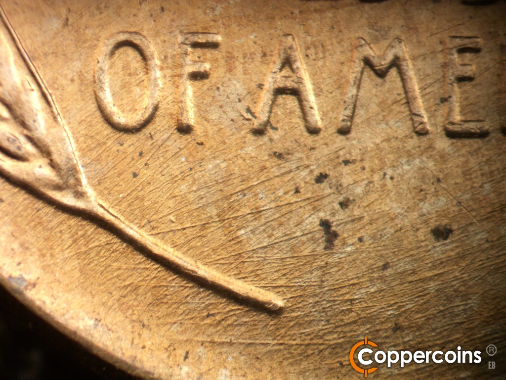 Die-stage C marker on 1958D•1MM•112 showing Die scratches cover lower left of reverse.