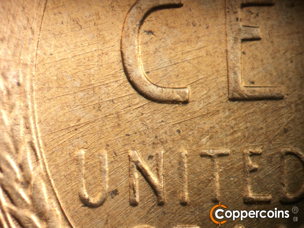 Die-stage C marker on 1958D•1MM•112 showing Die scratches cover left center of reverse.