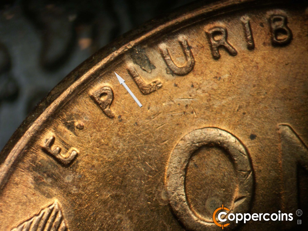 Die-stage B marker on 1958D•1MM•116 showing Concentric die scratch between rim and E PLURIBUS.