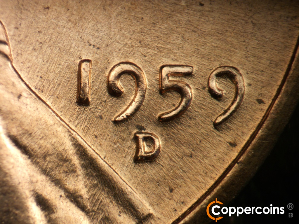 Die-stage B marker on 1959D•1DR•002 showing NNE die scratches from lapel into date.