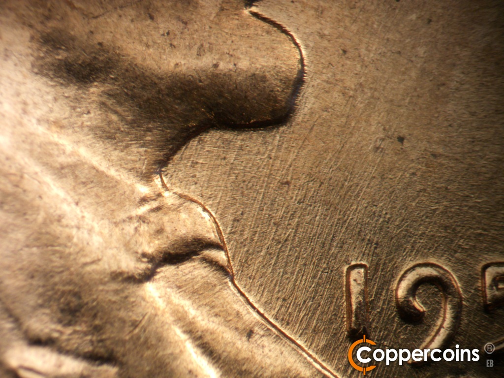 Die-stage B marker on 1959D•1DR•002 showing NNE die scratches in front of throat.