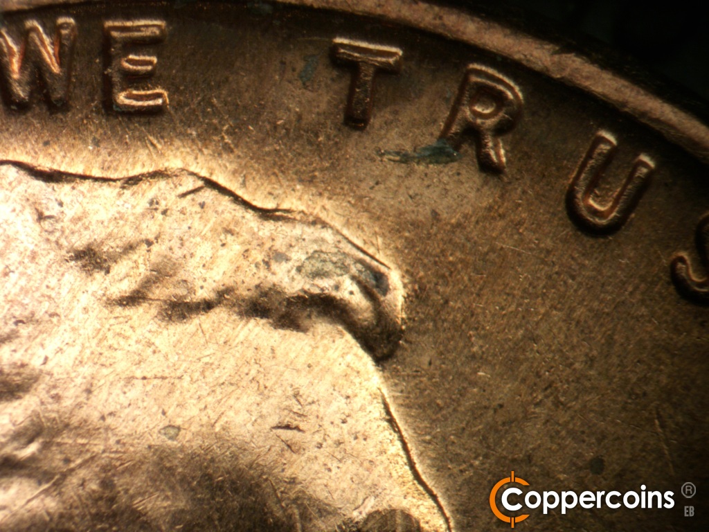 Die-stage B marker on 1959D•1MM•127 showing Short NW die scratches from top of hair toward WE.