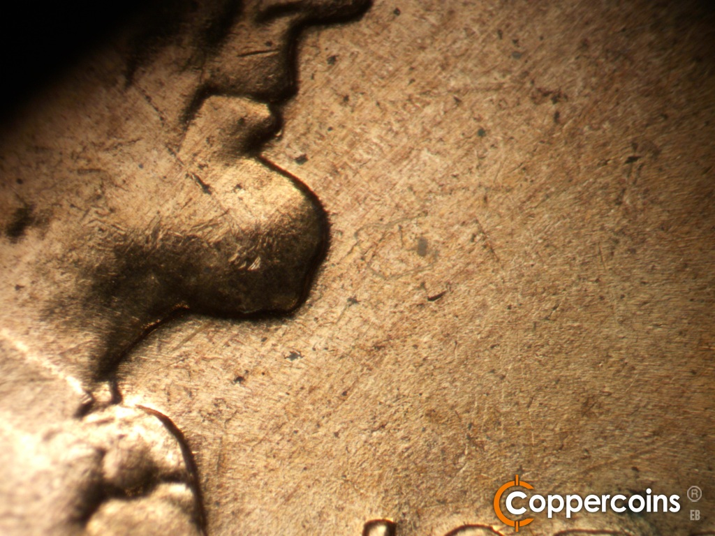 Die-stage B marker on 1959D•1MM•127 showing Worn SW die scratches from bottom of beard.