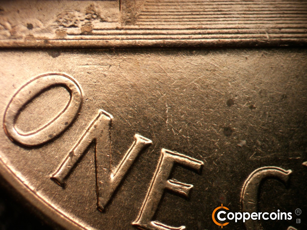 Die-stage B marker on 1959D•1MM•129 showing Light crossing die scratches under base.