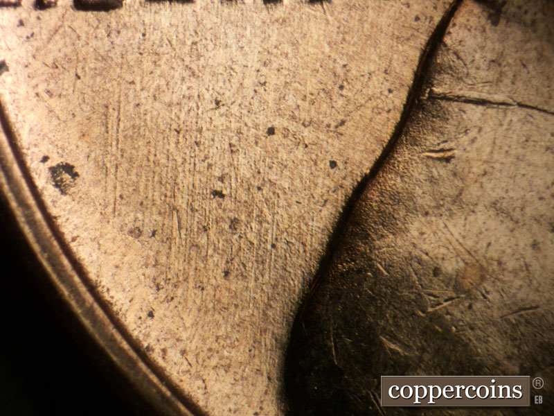 Die-stage B marker on 1960D•1DO•001 showing N-S die scratches under LIBERTY.