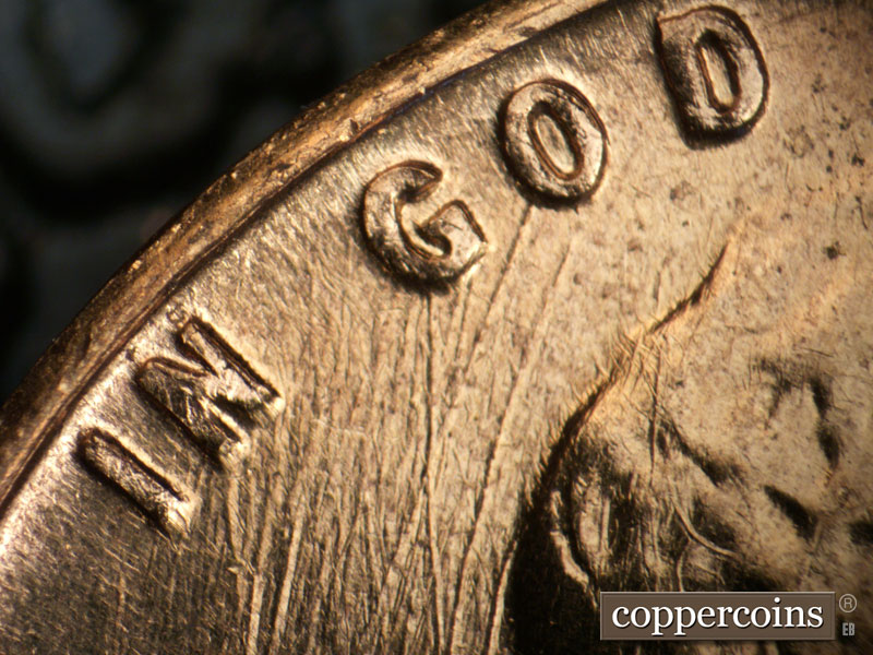 Die-stage B marker on 1960D•1DO•001 showing Heavy multidirectional die scratches from IN GOD.