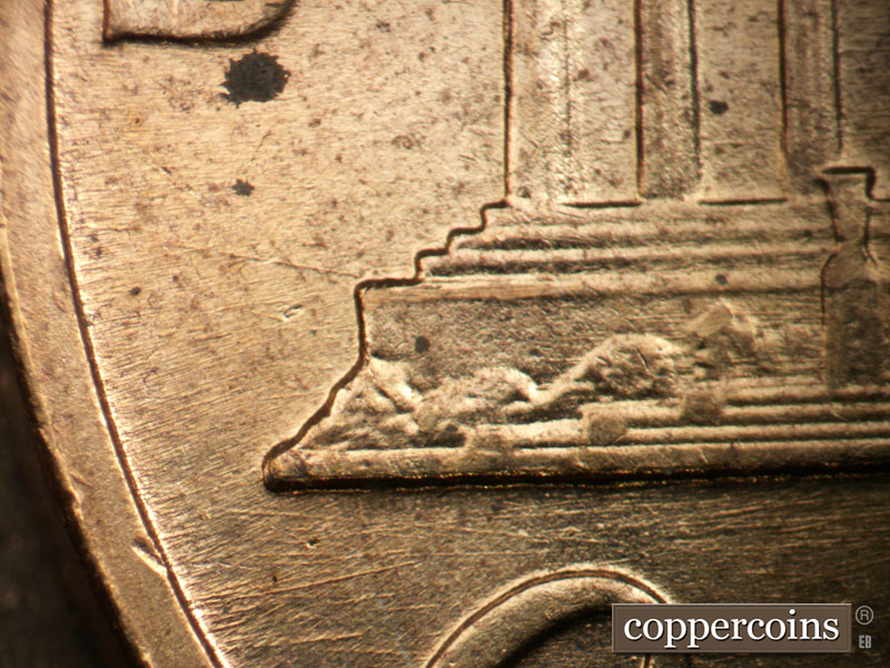Die-stage B marker on 1960D•1DO•001 showing E/W die scratches under left base.