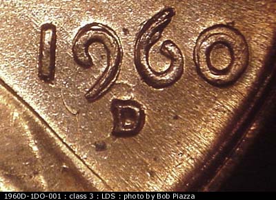 Die-stage C marker on 1960D•1DO•001 showing A die crack runs from the bottom of the 1 in the date south to the vest. NW-SE die scratches through date are nearly….