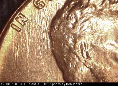 Die-stage C marker on 1960D•1DO•001 showing Extremely heavy N-S die scratches run through IN GOD and behind the head.