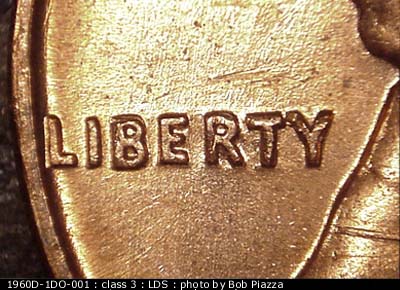 Die-stage C marker on 1960D•1DO•001 showing Die scratches through LIBERTY.