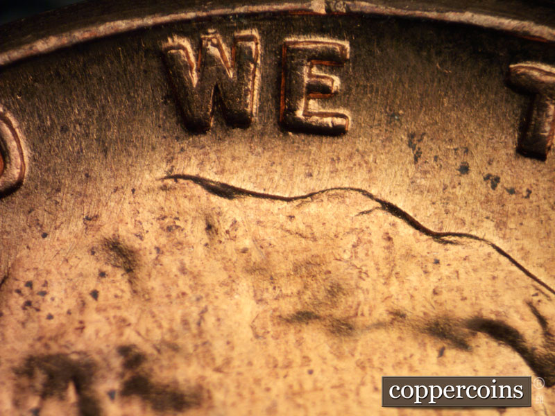 Die-stage B marker on 1960D•1DO•004 showing Light thickness on WE.
