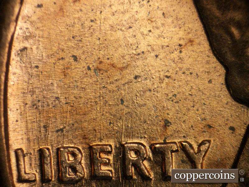 Die-stage B marker on 1960D•1DO•005 showing N/S die scratces though LIBERTY.